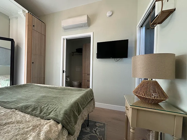 Bedroom #2 has its own ceiling fan and Euro-style wall-mounted heater/AC