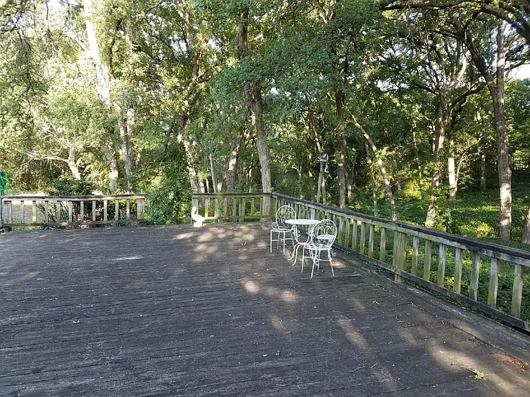 The large back patio is surrounded by tall trees with provide shades for most of the mornings and afternoons as well as during the day. The back yard has large trees which provide privacy.
