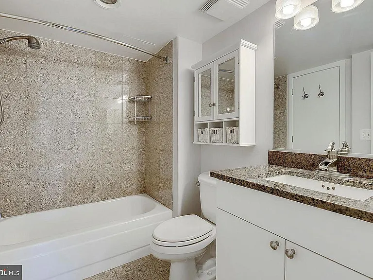 Bathroom with granite countertops and tile