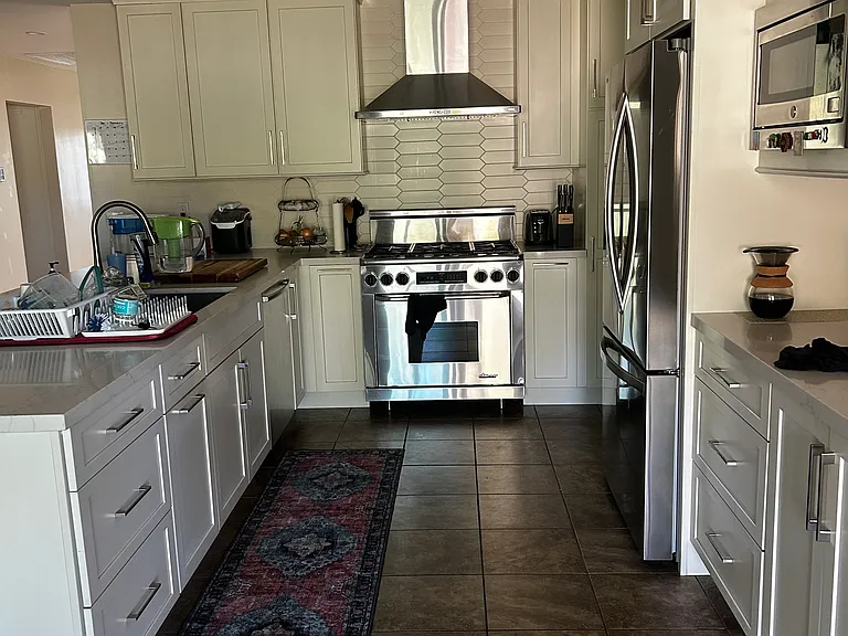 Shared kitchen and dining area/flex space to the left. Leads to the large room available for rent