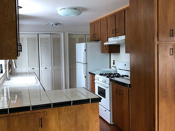 Full kitchen with gas range, laundry, dishwasher- washer and dryer behind closet doors.