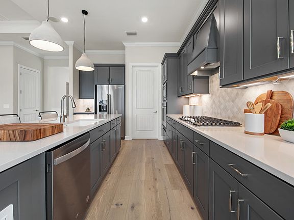 Designer finishes, stainless steel appliances and stylish kitchen backsplash