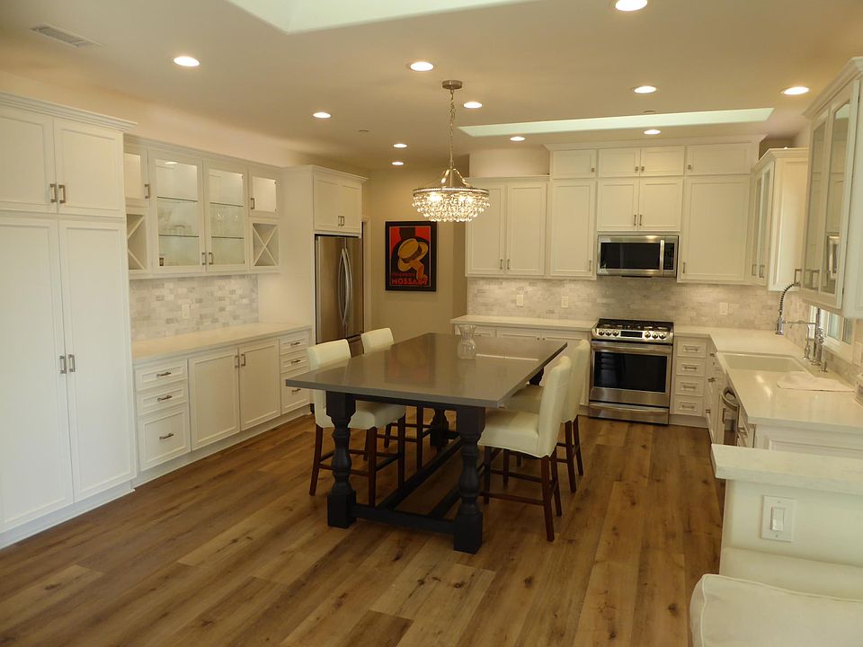 High end custom Kitchen cabinets with center table and chairs.