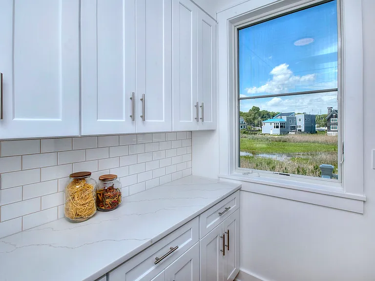 Private pantry closet fills with sunlight.