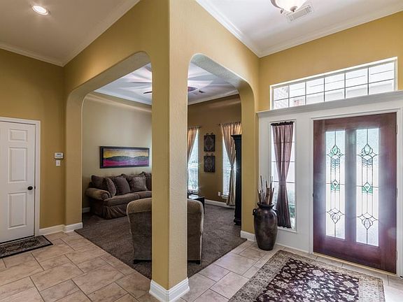 Elegant foyer with arches into the formal den.