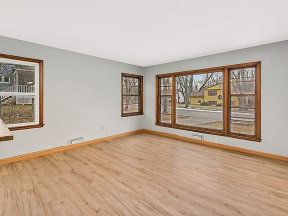 Large front living room with plenty of windows and light.