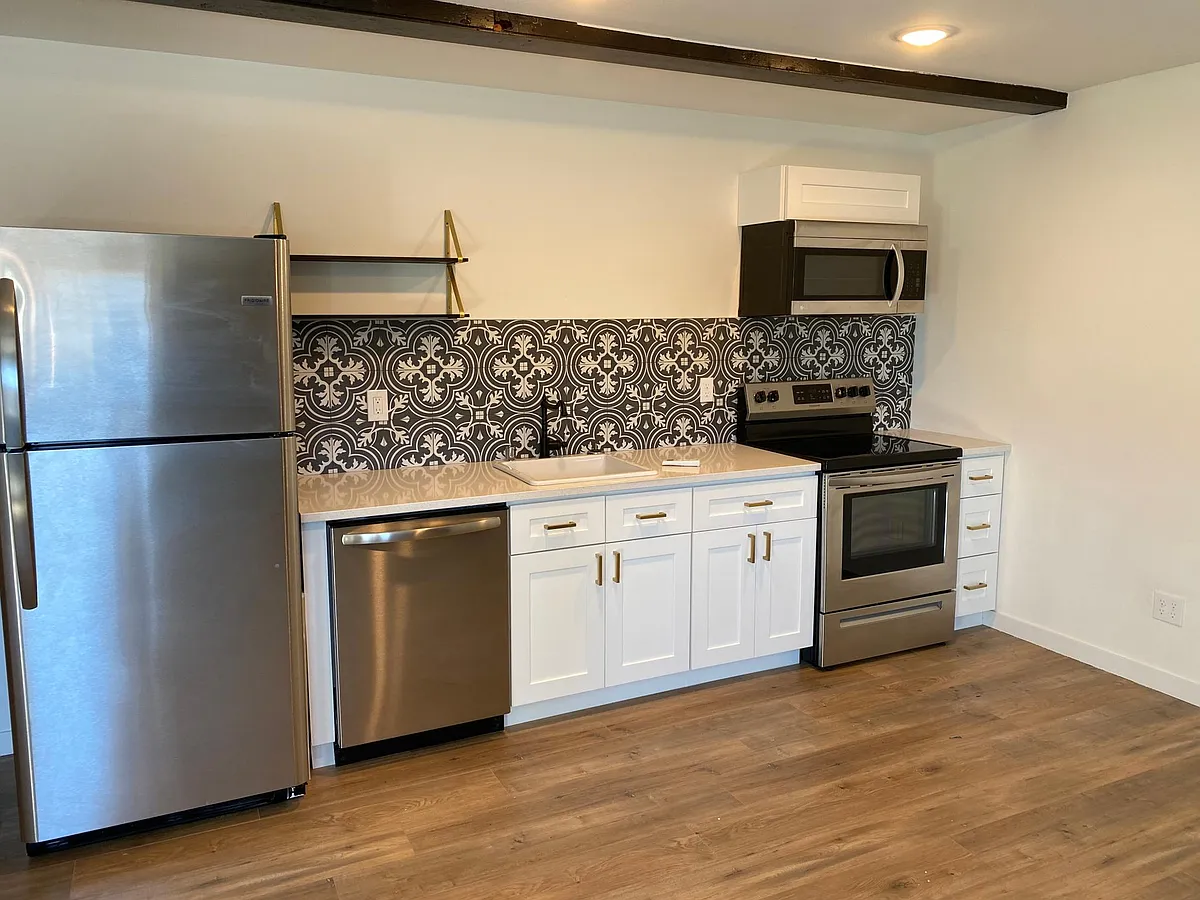 kitchen with Quartz counters, new stainless appliances and designer tile - 174 S Howard St #5