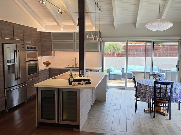 Chef's kitchen open to eating area and views of the garden.