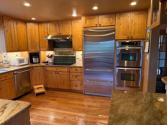 Kitchen with Subzero refrigerator, Kitchen Aid double convection ovens, and a Kitchen Aid dishwasher.