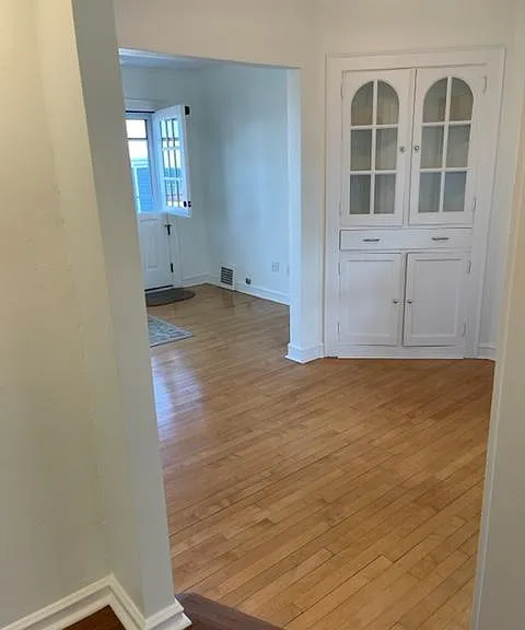 Dining/sitting room with original built-in and maple floors. Lots of natural light. Leads to Living Room.