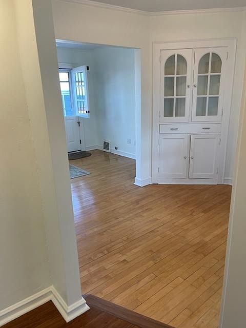 Dining/sitting room with original built-in and maple floors. Lots of natural light. Leads to Living Room.