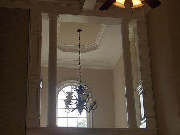Stunning 2-story foyer has exquisite trim, double stacked columns
