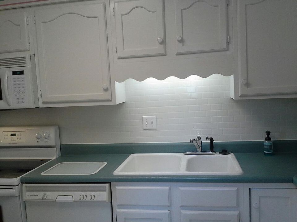 Kitchen with built-in cutting board, vegetable sink and garbage disposal.