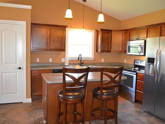 Vaulted kitchen with tile flooring.