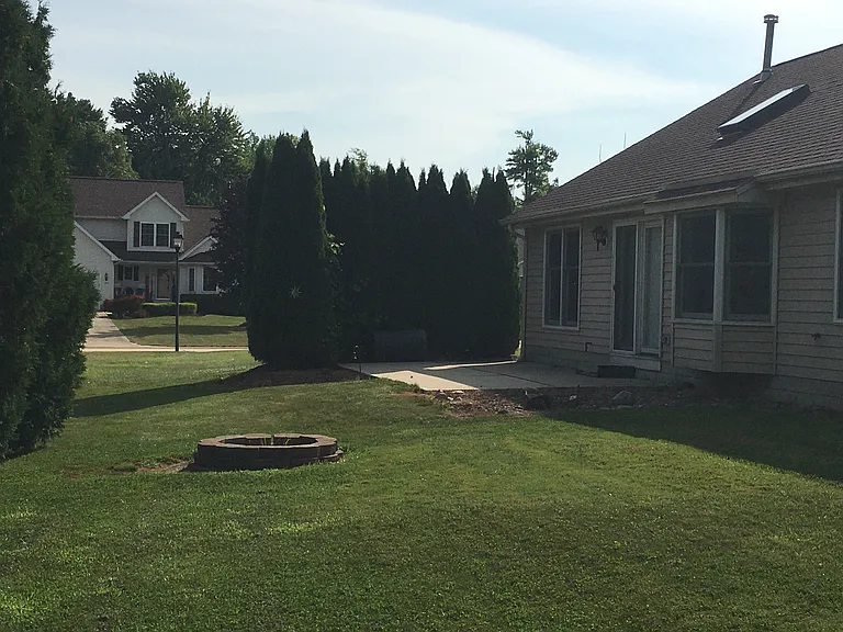 Rear exterior door has step-out private 22'X11' patio