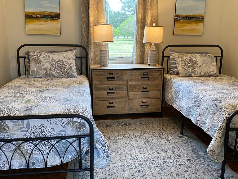 Two twin beds and dresser complete the second bedroom
