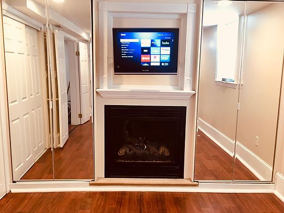 East Wall of Living Room shows gas fireplace and wall mounted TV.