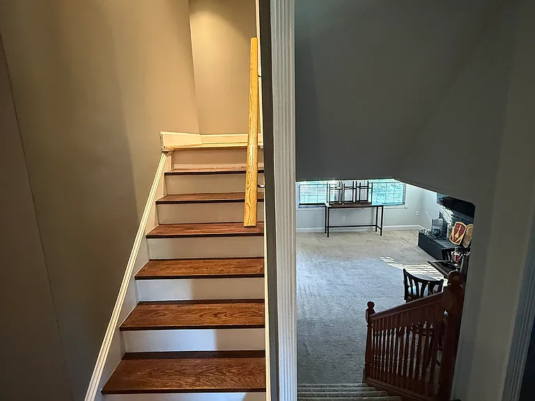 When stepping inside, there are stairs to go to the upper level and stairs to the lower level.