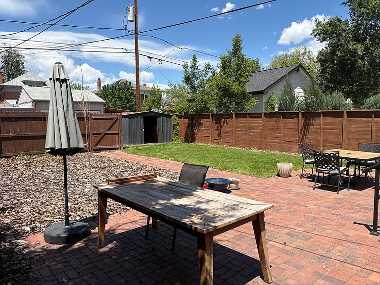 private, fully fenced back yard. dining table and chairs and patio furniture can stay if wanted.