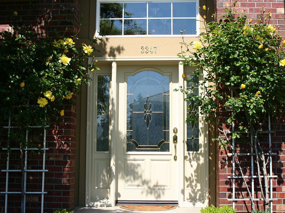 Front door framed by climbing roses