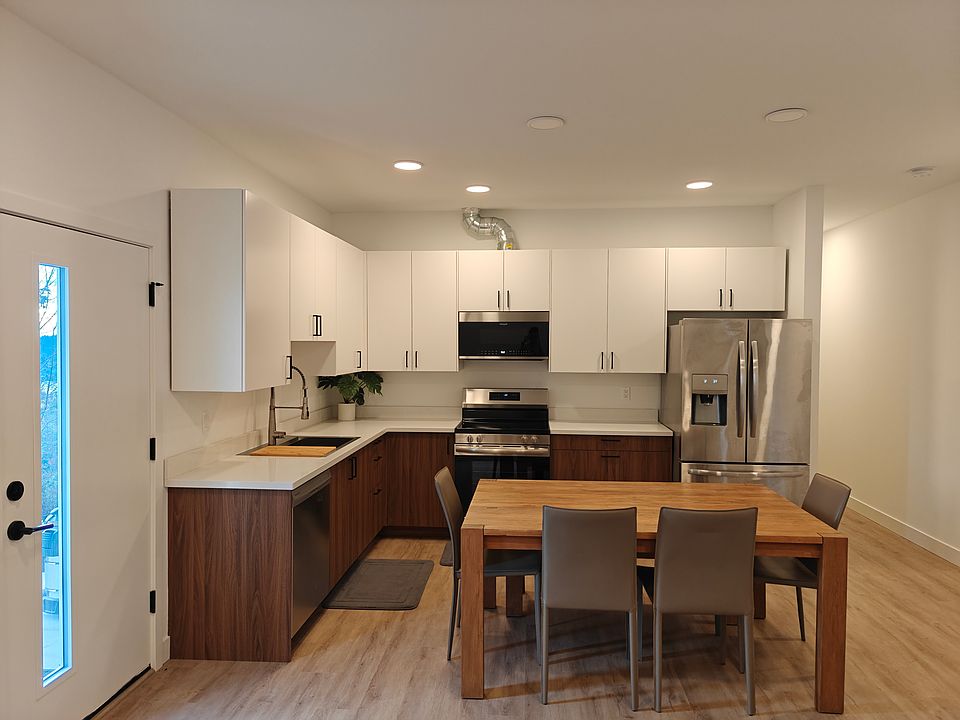 Two tone kitchen with brand new cabinets and stainless steel appliances.