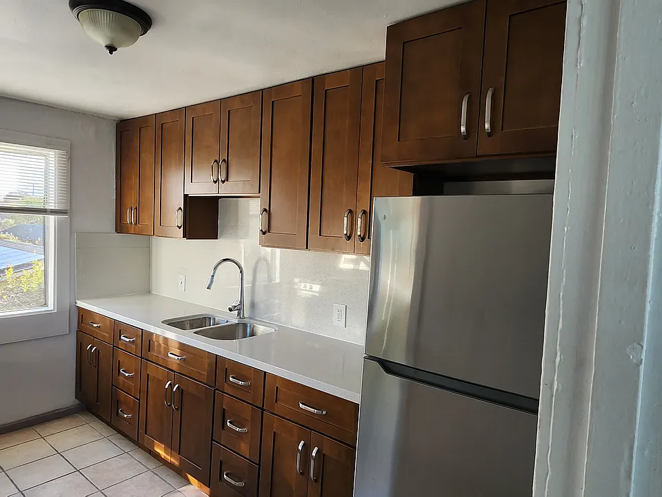 Remodeled kitchen with new countertops along with new sink and fridge.