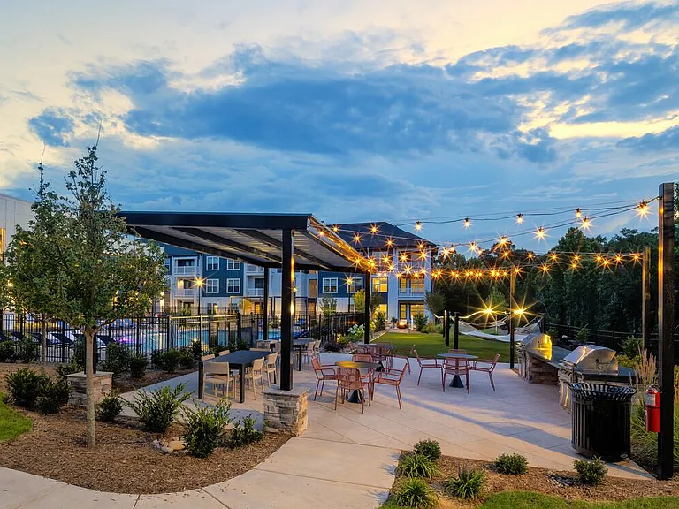 Courtyard with grills, seating, and hammocks