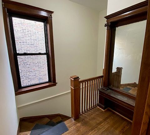 Front hall with built-in mirror and seating