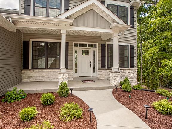 The charming front porch frames the front door with keyless entry.