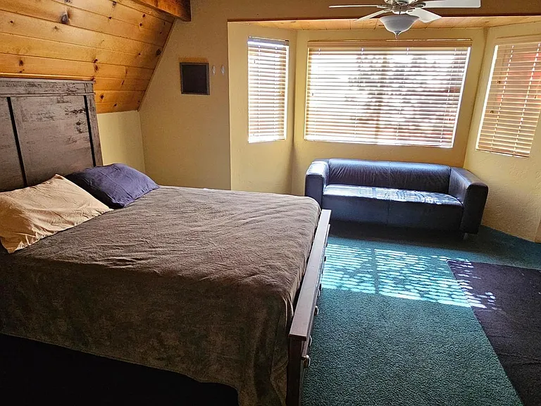 Second large bedroom with wood burning heater.
