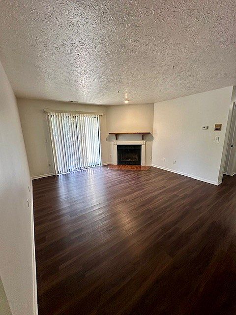 Living room and wood-burning fireplace of 2261 D. Sliding glass doors to patio