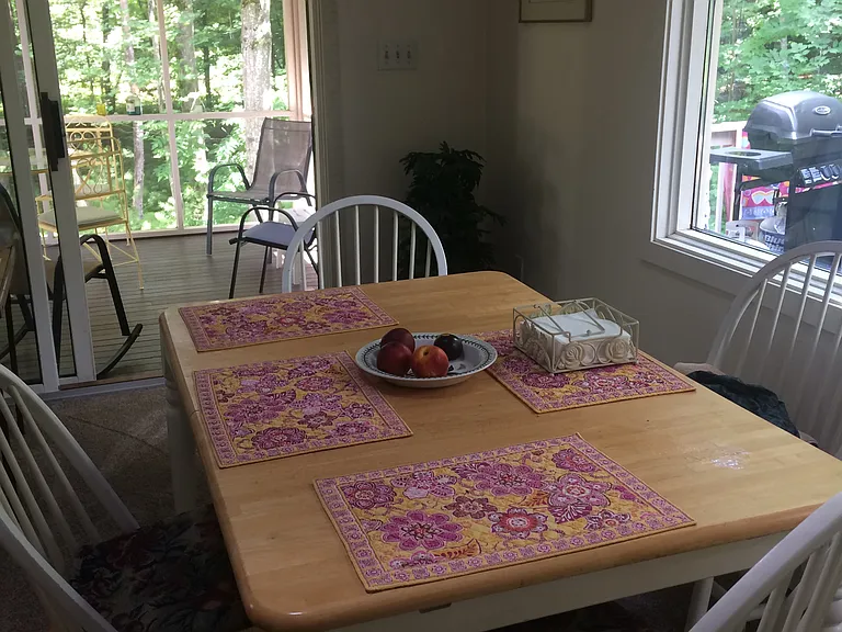 Dining table with screened porch beyond