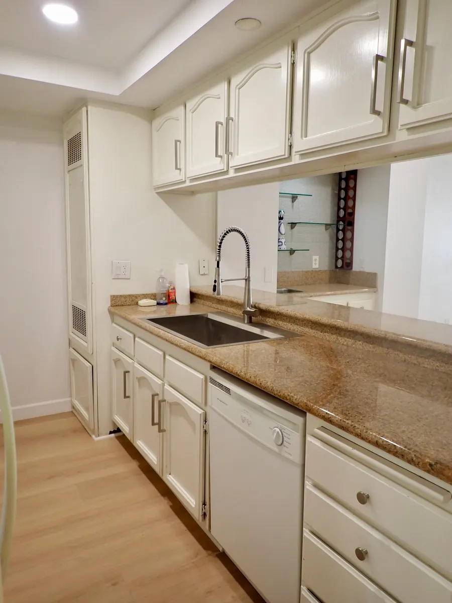 Galley kitchen with lots of cabinet space - 11600 Warner Ave #435