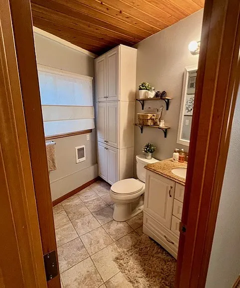 3/4 Bathroom with shower. 
Tile floor, granite countertop and individual "booster" wall heater.

(Sorry, no bathtub)