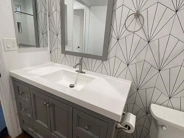Floor to ceiling tile. Laminate flooring all throughout.