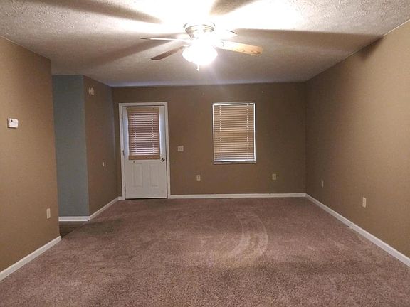 One end of living room.Kitchen to left.