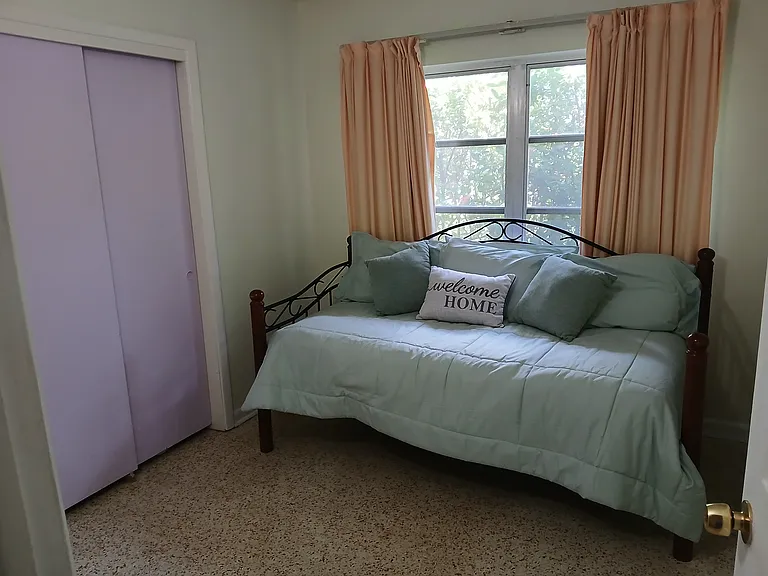 This is the smallest bedroom that I could leave this daybed, because a single bed is all that can fit in this room, and it's a perfect space that has room for a desk for an office. The drapes really darkens the room for deep sleeping.