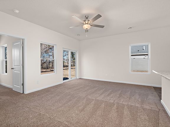 The family room is spacious with a ceiling fan.