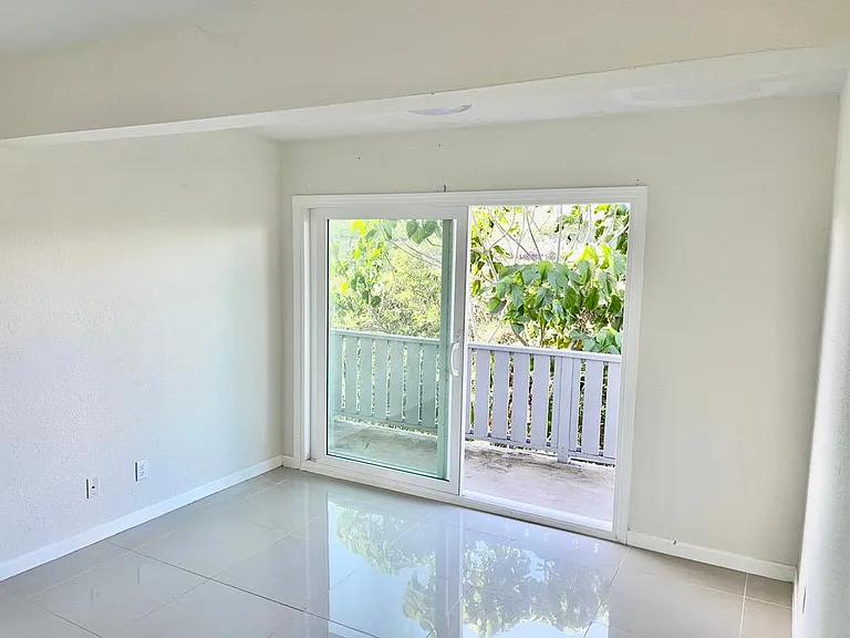 Bedroom 1 with sliding door opening to deck.