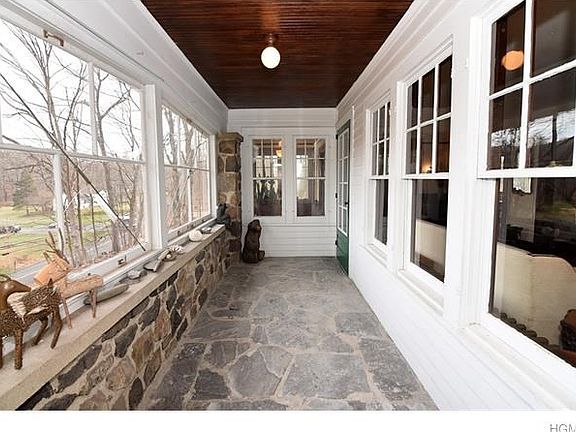 Sun filled stone entry foyer overlooking sweeping yard.