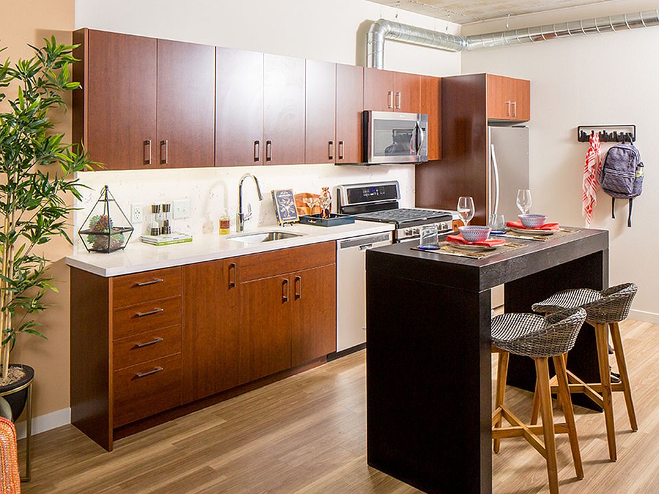 Modern kitchens outfitted with stainless steel appliances, and quartz countertops with tile backsplashes