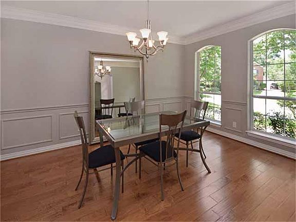 Large Formal Dining Features Hand Scraped Maple Flooring, Chair Rail, Wood Trim Accents and Beautifu