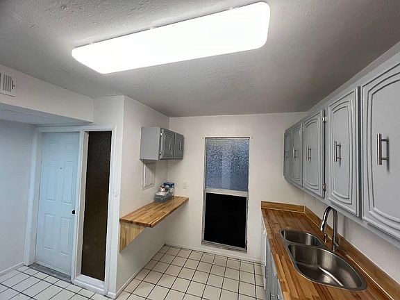 Kitchen side view with brand new deep dual sink and privacy window.