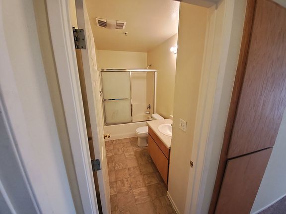 Hallway linen closets immediately next to a full bathroom.