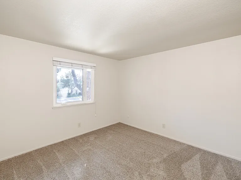 Comfortably sized and freshly carpeted, Bedroom D offers a quiet and versatile space ideal for rest.