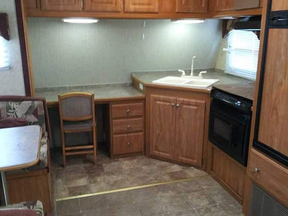 Kitchen area with office nook, fridge and freezer