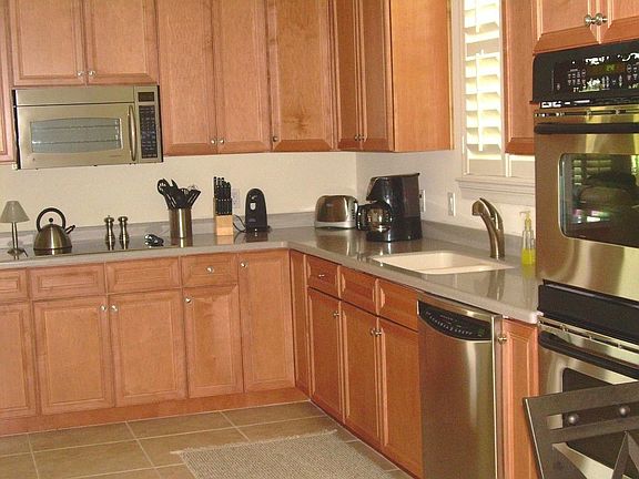large kitchen with stainless appliances and beautiful cabinets