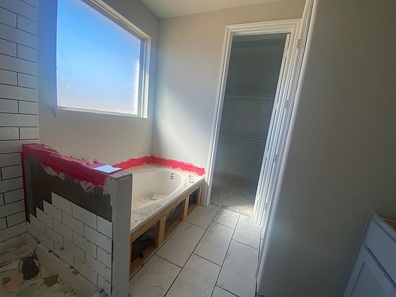 Primary bathroom with modern tile surround - progress photo