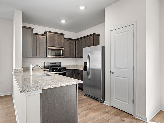 The kitchen of the Primrose has sprawling granite countertops.