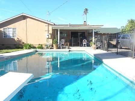 Rear yard offers gated sparkling pool 